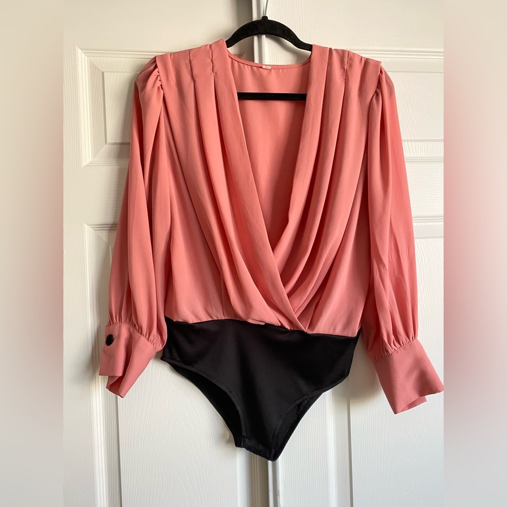 Sheer pink bodysuit with black poly blend bottom. One piece.